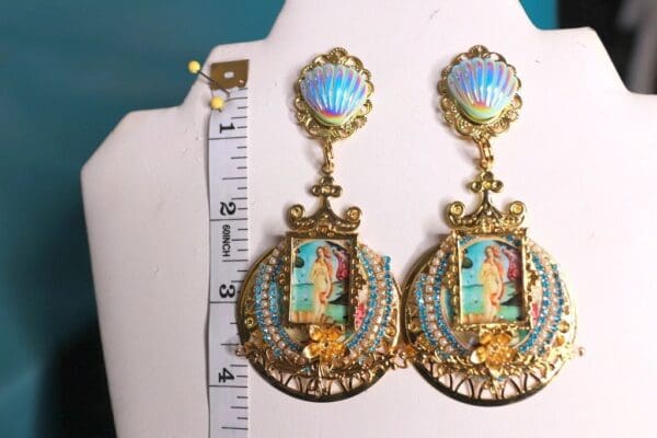 A pair of earrings with a picture on them