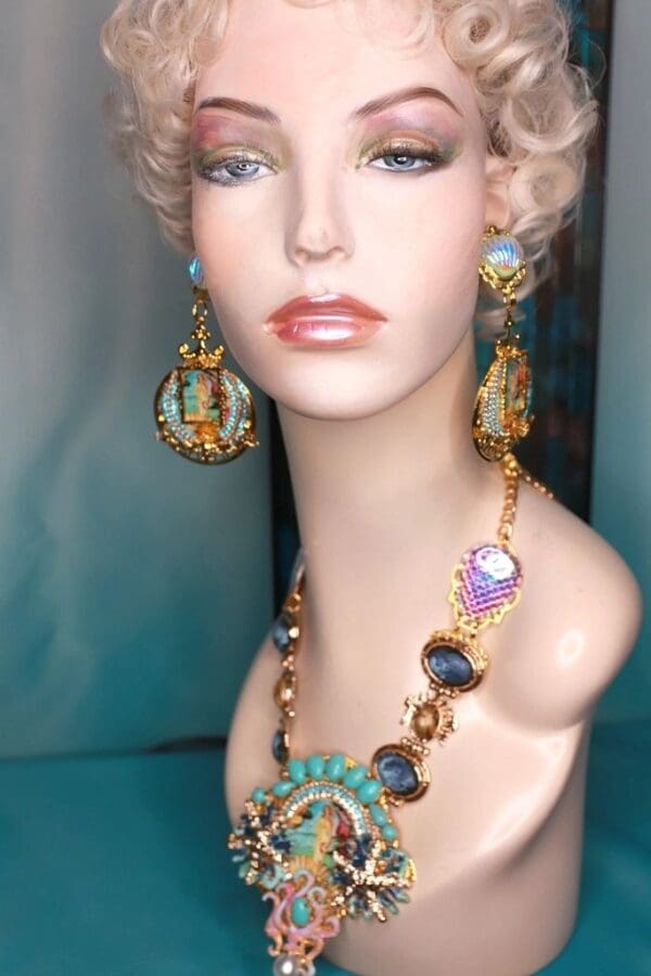 A mannequin wearing jewelry and earrings.