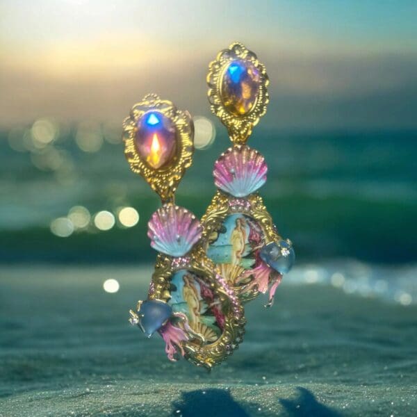 A pair of earrings sitting on top of the sand.