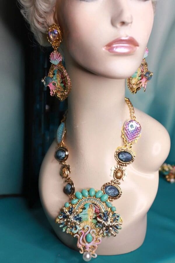 A mannequin wearing a necklace and earrings.