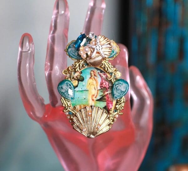 A pink hand with a ring on it