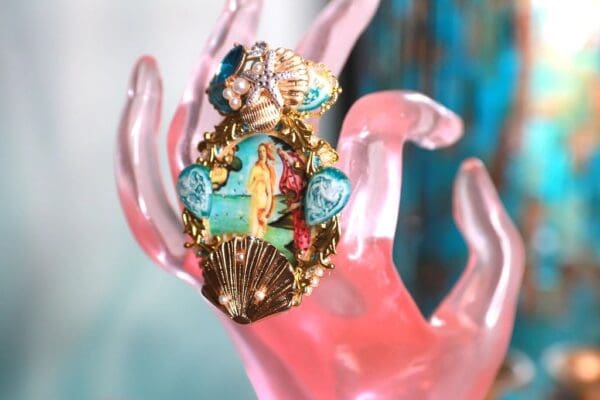 A close up of a hand wearing a ring