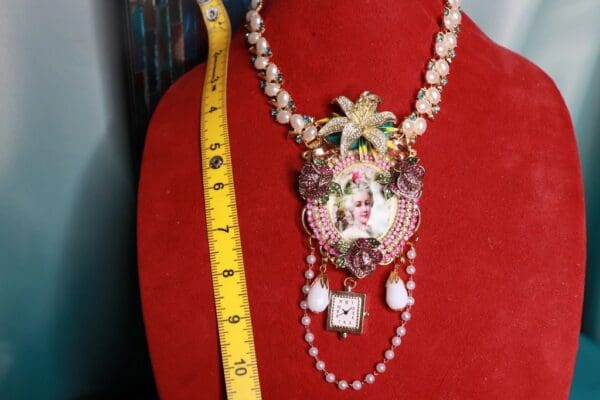 A red dress with a necklace and measuring tape