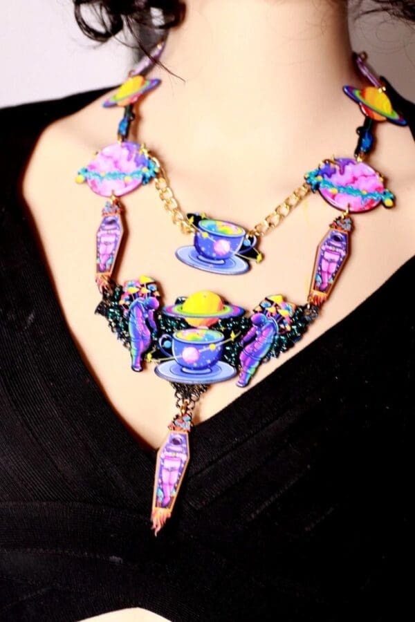 A woman wearing a necklace with colorful beads.
