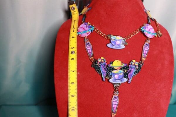 A red display with a necklace and bracelet on it