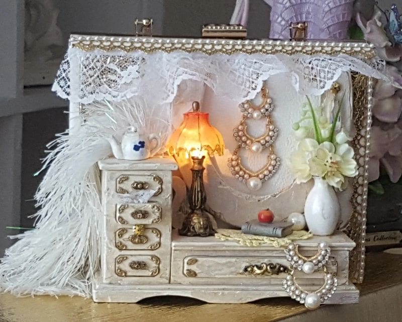 A white box with some jewelry on it