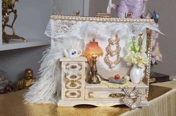 A table with a white dresser and some flowers