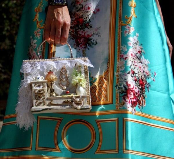 A woman holding a purse in her hand.