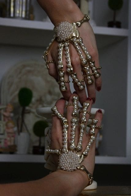 A pair of hands with skeleton hands on them.