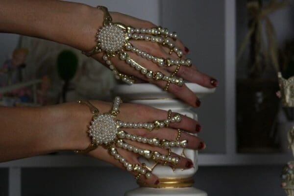 A woman 's hands with jewelry on them