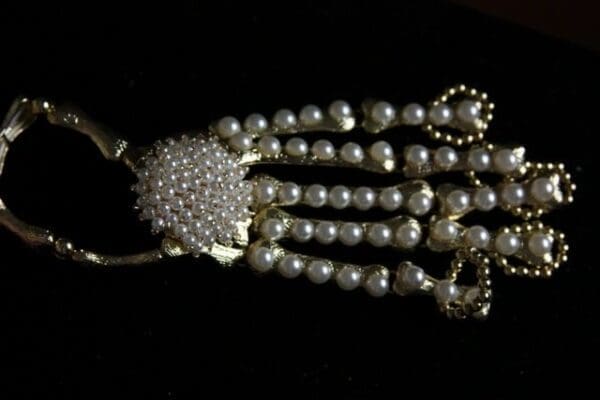 A close up of the necklace on someones wrist