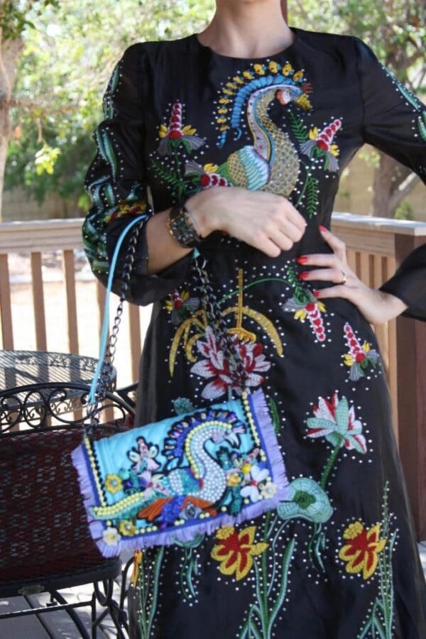 A woman in a dress holding onto a purse