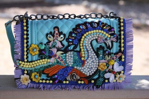 A purse with beads and sequins on it.