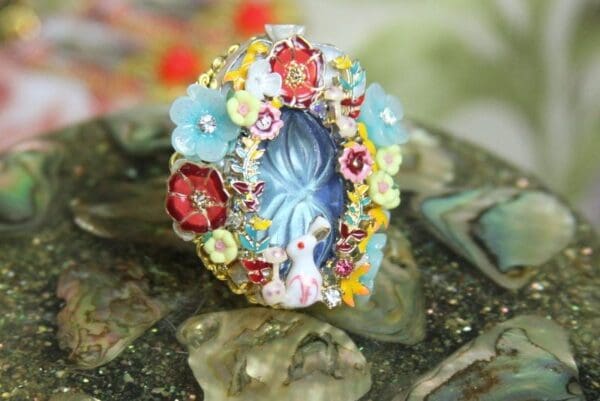 A ring with flowers and a blue face