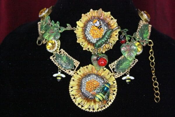 A necklace with sunflowers and other flowers on it.