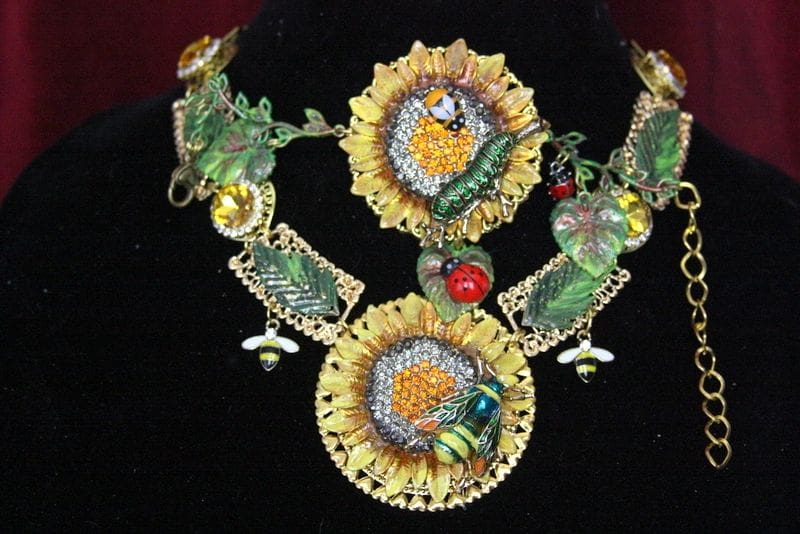 A necklace with sunflowers and other flowers on it.