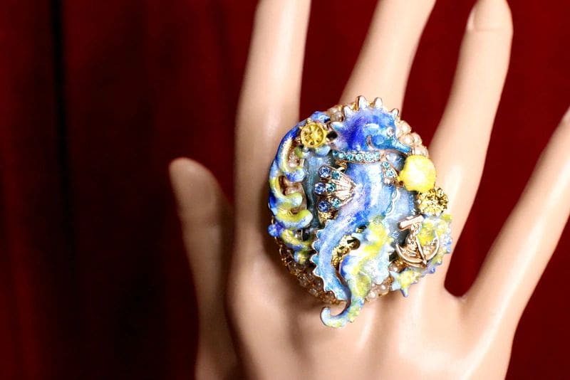 A woman 's hand wearing an octopus ring.