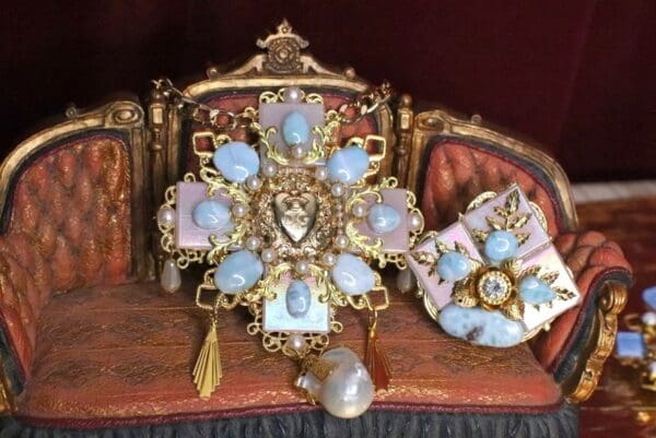 A cross with blue stones on top of it.