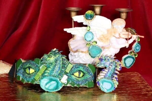 A pair of green dragon shoes sitting on top of a table.