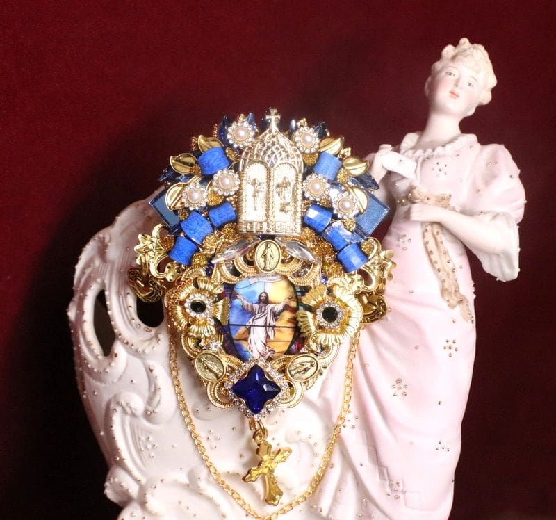 A statue of a woman holding a necklace.