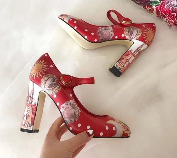 A pair of red shoes with floral designs on them.