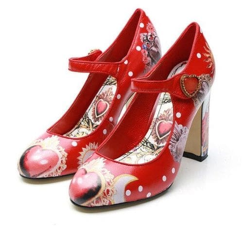 A pair of red shoes with white hearts and polka dots.