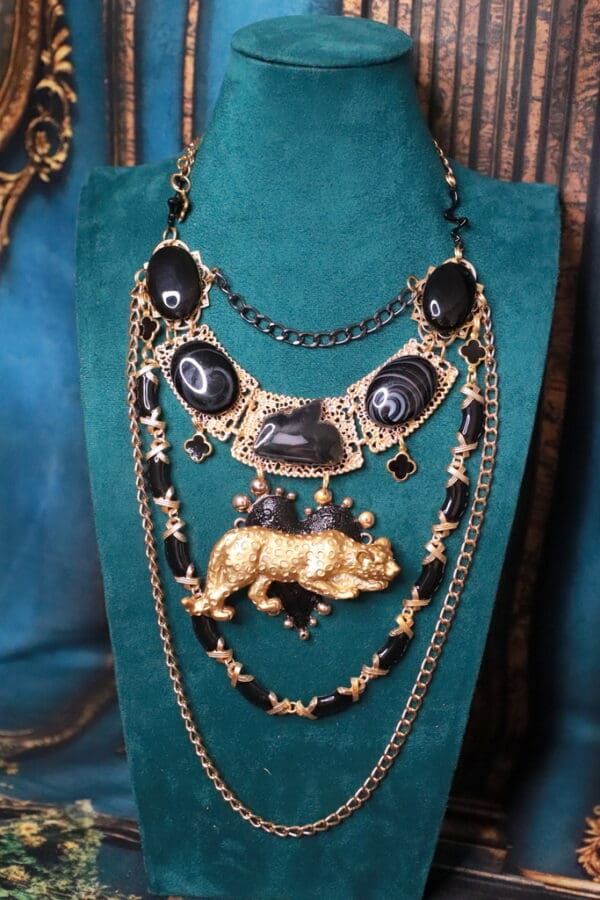 A necklace with black and gold beads on it