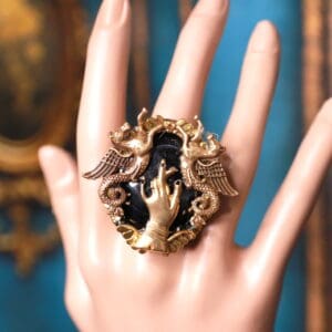 A hand is holding onto the ring of jewelry