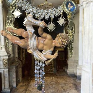 A statue of a man in chains hanging from the ceiling.