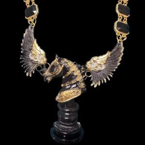 A black and gold necklace with a horse statue.