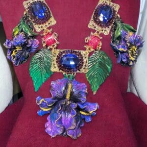 A red chair with a purple flower and some green leaves