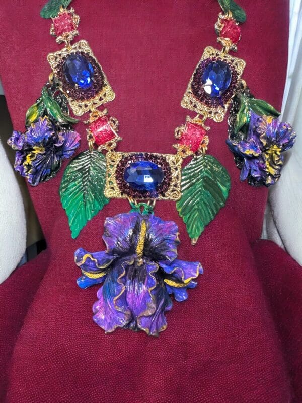 A red chair with a purple flower and some green leaves