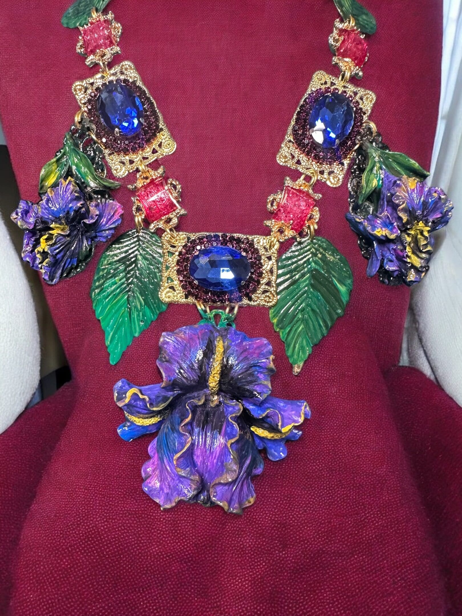 A red chair with a purple flower and some green leaves