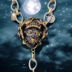 A necklace with chains and a face on it