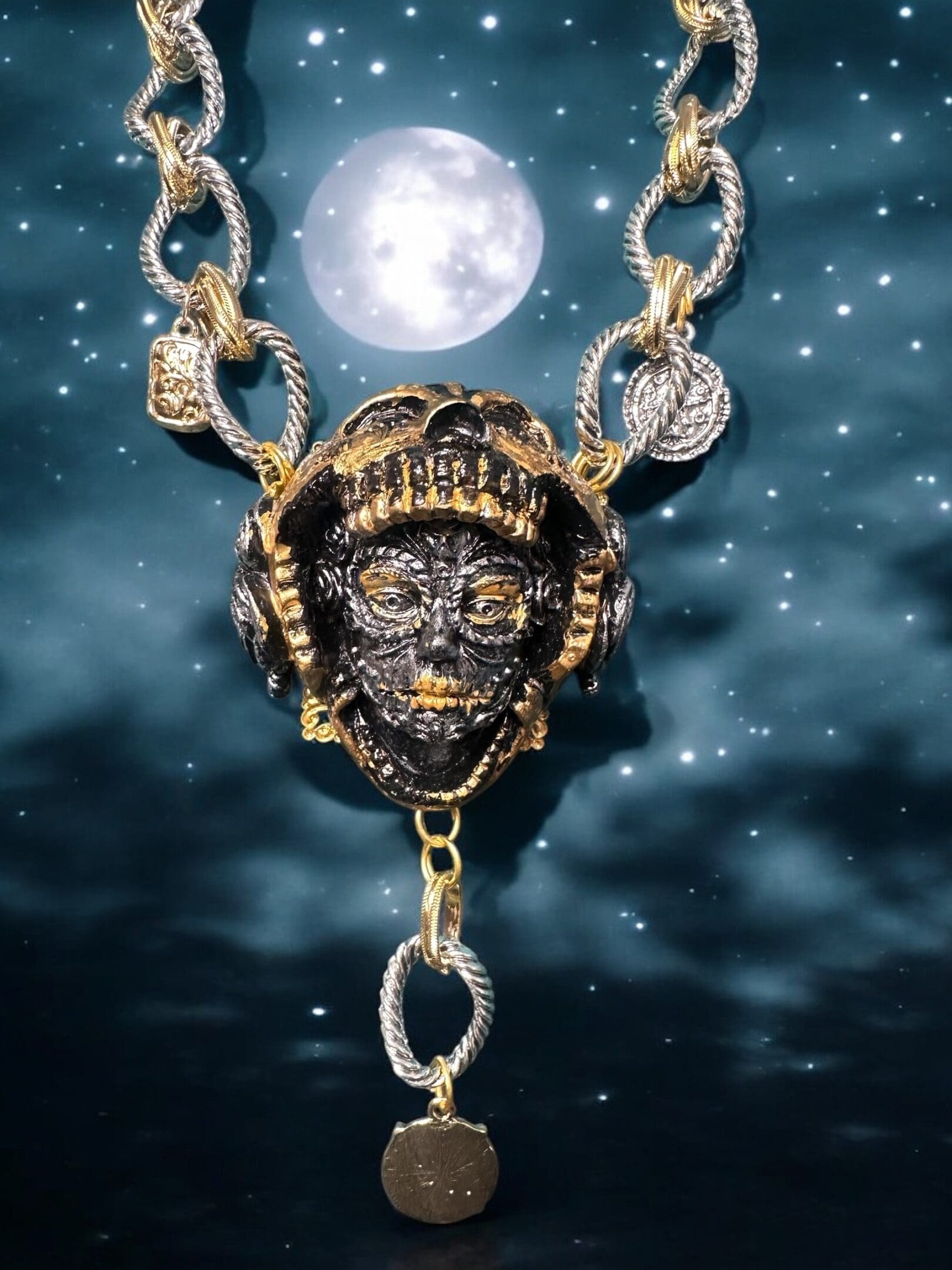 A necklace with chains and a face on it