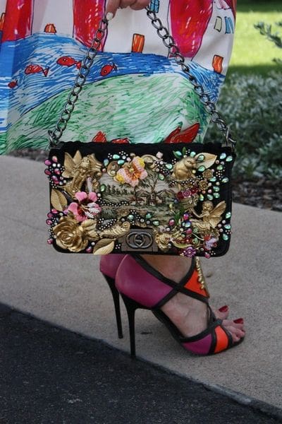 A woman 's shoe and purse on the street.