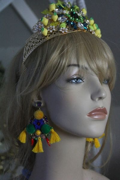 A mannequin wearing a crown and earrings.