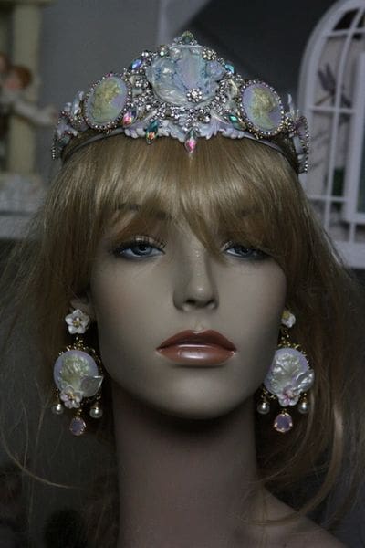 A mannequin wearing a tiara and earrings.