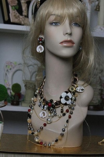 A mannequin wearing jewelry and earrings in a store.