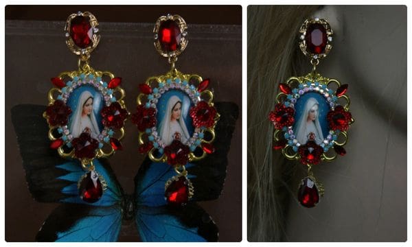 A pair of earrings with a picture of jesus.