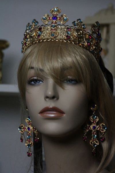 A mannequin wearing a crown and earrings.