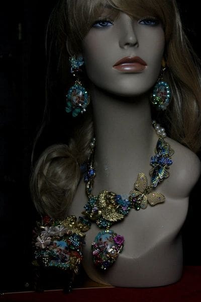 A mannequin wearing jewelry and earrings in the dark.