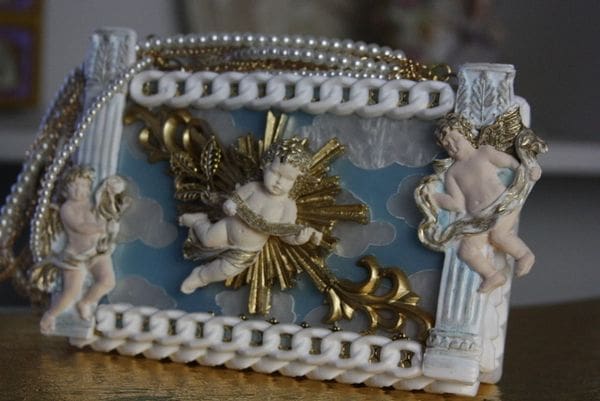 A picture frame with angels on it