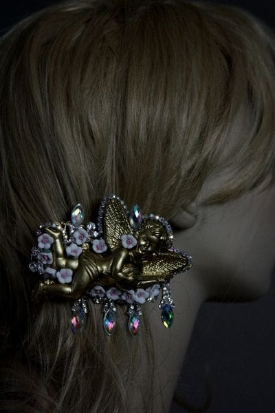 A woman with blonde hair wearing a gold and crystal butterfly clip.
