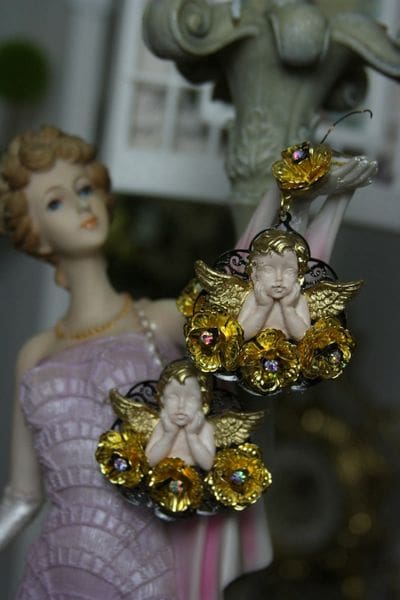 A statue of a woman in purple dress and gold earrings.