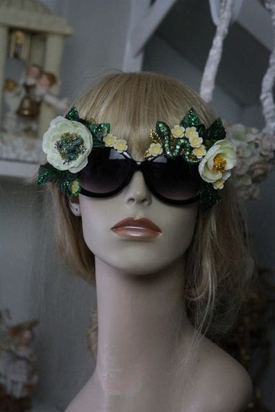 A mannequin wearing sunglasses with flowers on them.