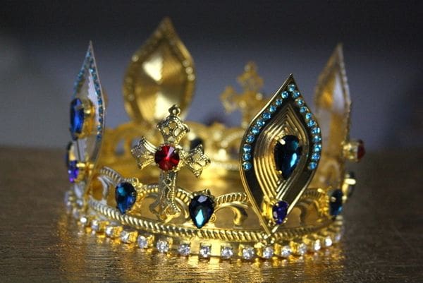 A gold crown with jewels on it.