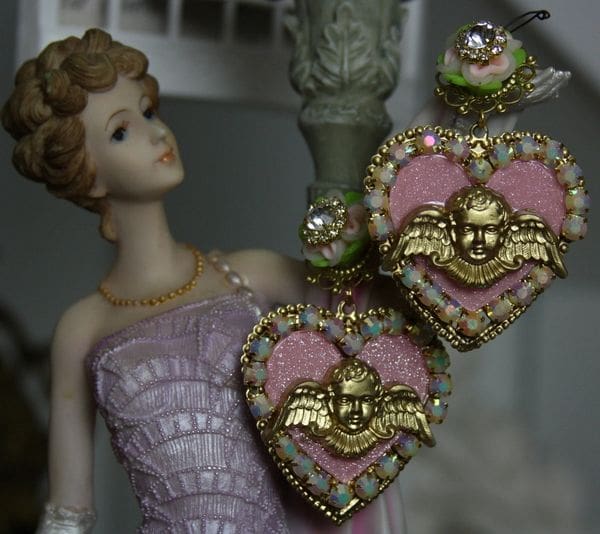 A statue of a woman wearing pink and gold jewelry.