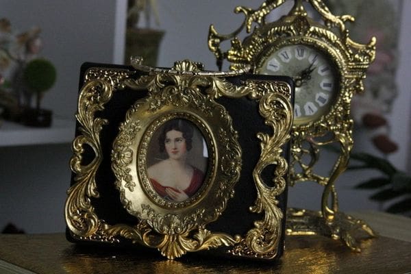 A picture of a woman in a gold frame.