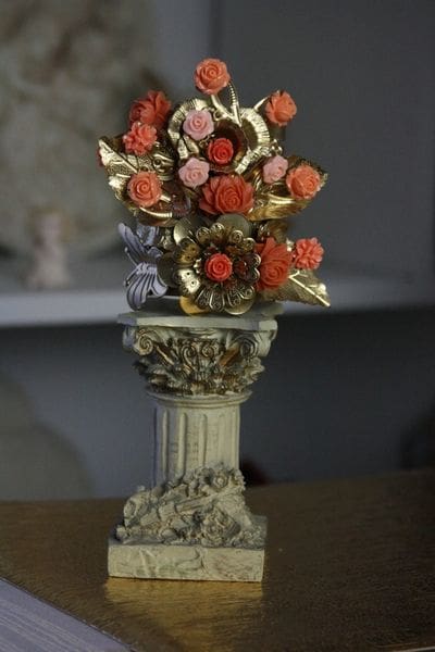 A vase with flowers on top of it